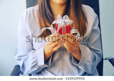 Woman hold red gift box on her hands 