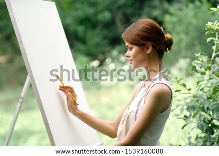 woman in nature resting paints a picture