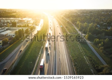 Drone view of Poznan traffic highway, with sunset background. Royalty-Free Stock Photo #1539165923