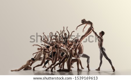 Support. Group of modern ballet dancers. Contemporary art. Young flexible athletic men and women in tights. Negative space. Concept of dance grace, inspiration, creativity. Made of shots of 11 models. Royalty-Free Stock Photo #1539169613