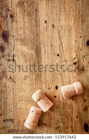 Bottle corks for champagne or wine on a wooden background with copyspace for your festive or New Year greeting
