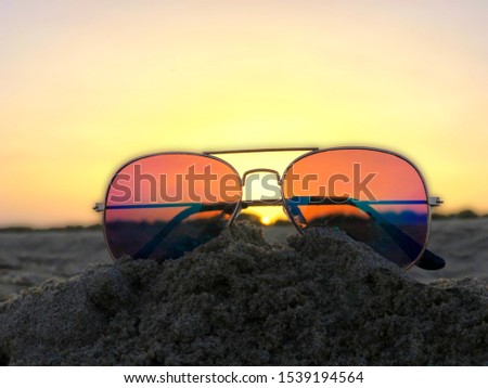 sunglasses on the beach in summer day