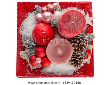 Holiday decoration with candles, cones and snow.Top view. Isolated on white