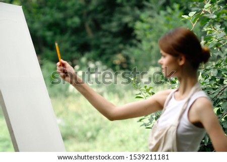 woman model easel paints on canvas young