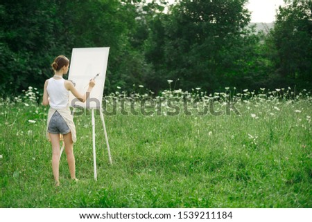 woman model easel paints on canvas young