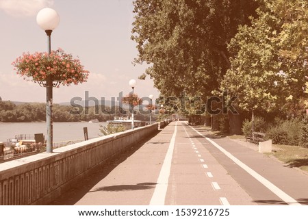 Bratislava, capital city of Slovakia. Danube river waterfront - cycling path along embankment. Vintage filtered colors style.