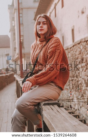 Stylish girl in knitted sweater. Fashion. Woman with dark hair. Autumn shooting