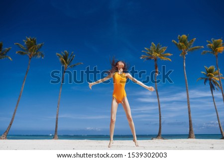 Woman in yellow swimsuit nature fresh air palm tropics island