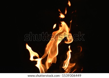 red hot flames in darkness on black background
