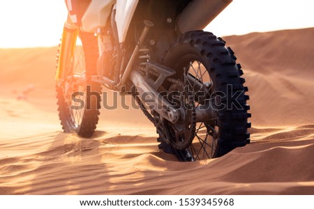 close up of motocross in the desert in sunset time 