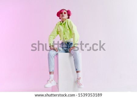 young woman with a beautiful smile in bright clothes looks at the camera