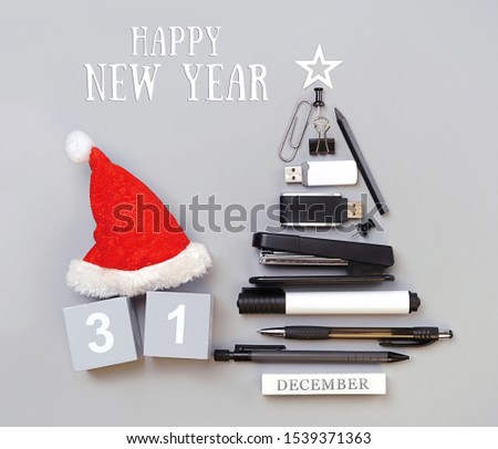Happy New Year. symbol Christmas tree made of stationery, office supplies on gray background. new year's concept in office, University, school. Creative idea design. flat lay