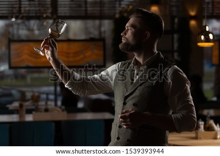 
Sommelier evaluates wine in a glass Royalty-Free Stock Photo #1539393944