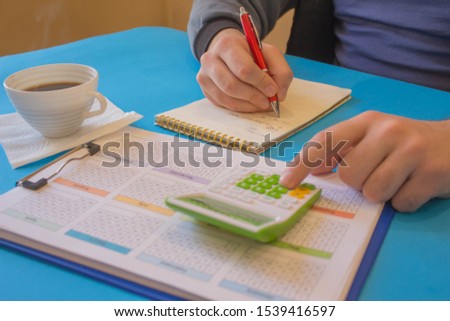 Hands of accountant with calculator and pen. Accounting background. Man using a calculator to calculate the numbers. Man hand with calculator