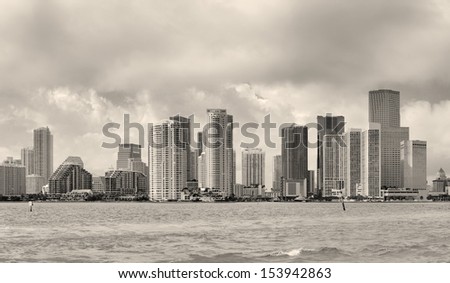 Miami skyline panorama in black and white in the day with urban skyscrapers and cloudy sky over sea 