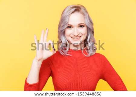 Woman model sowing ok sign isolated.