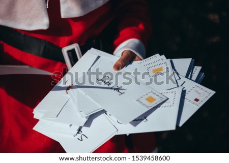 Stock photo of Mama noel watching and organizing Christmas letters in the middle of the street. Christmas time