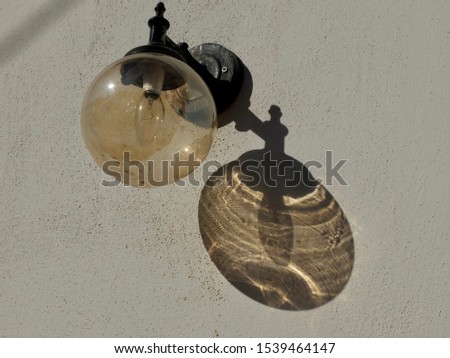 Round glass street lamp with shadow