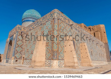 TRANSLATION: "Muslim Prayer Sentences". Turkestan Mausoleum of Khoja Ahmed Yasawi Breathtaking Picturesque View on a Sunny Blue Sky Day