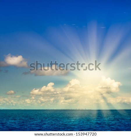 Idyllic ocean sky clouds and sunlight scene