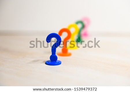 Problem solution illustrated with play figures in question mark form in bright colors against white background.