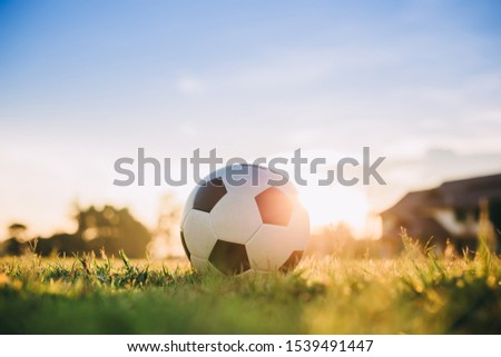 A ball for street soccer football under the sunset ray light. Film picture style and exercise in the morning concept.