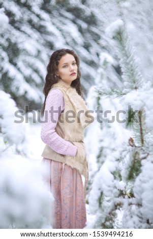 beautiful girl walks in the winter forest, winter fairy tale