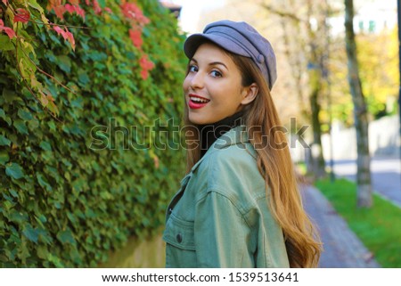 Portrait of fashion young woman with hat, polo neck and jacket in Autumn outdoors.