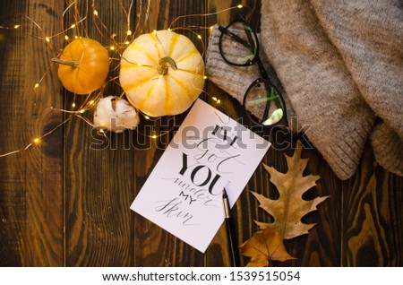fall postcard and autumn leaves and details Mockup with pumpkin and light on wooden background.