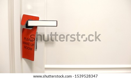 Please make up room red sign hanging on doorknob , hotel cleaning services