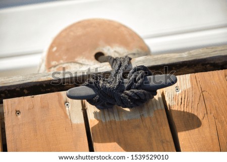 Dock rope perfectly placed in a deck Royalty-Free Stock Photo #1539529010