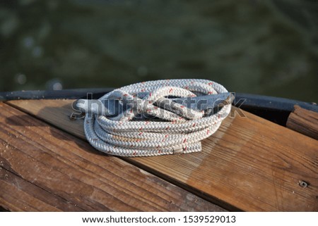 Dock rope perfectly placed in a deck Royalty-Free Stock Photo #1539529013