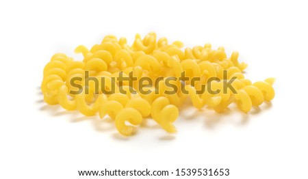 Raw yellow cavatappi pasta isolated on white background. Pile of dry uncooked noodles or wheat spiral macaroni closeup Royalty-Free Stock Photo #1539531653