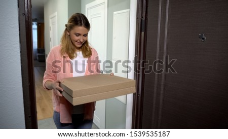 Woman holding pizza box, satisfied with timely delivery, good service, fast food