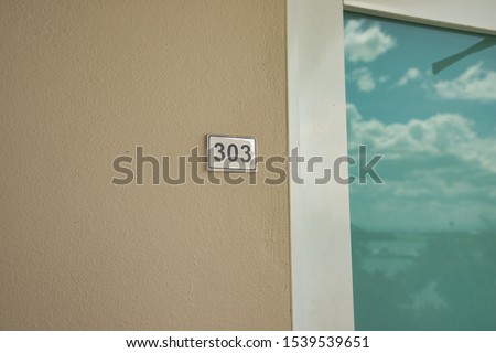Room 303 Sign and door entrance Royalty-Free Stock Photo #1539539651