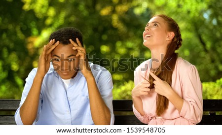 Mixed-race guy shocked by too talkative and annoying girl during first date Royalty-Free Stock Photo #1539548705