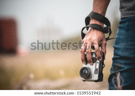 Photographer holding a vintage camera