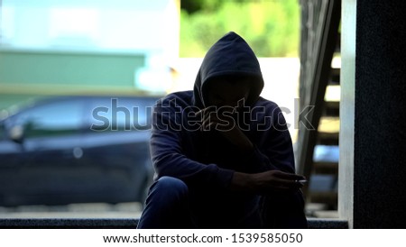 Teenage boy inhaling bitter smoke of cigarette and starting to cough, smoking