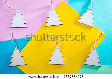 Top above high angle closeup overhead view photo of nice beautiful christmas decoration lying on pink, blue, yellow paper background