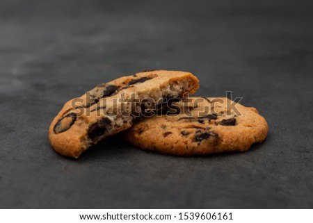 chocolate oatmeal cookies lie on a black marble background