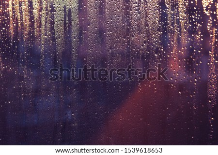 Abstract background. Flowing down rain drops in sunlight
