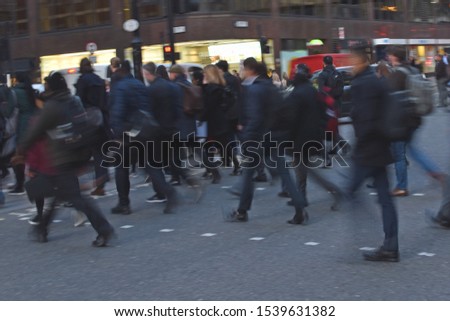 Blurred London commuters in rush hour. No recognisable people, logos or landmarks.
