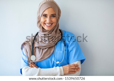 Confident Muslim female doctor standing inside hospital. Portrait of Muslim Doctor with stethoscope. Confident Muslim medical student pose at hospital. Confident Muslim doctor