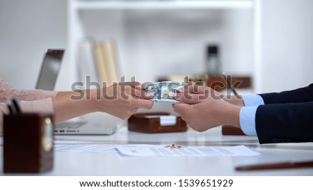 Male and female hands pulling money, dividing marital property during divorce Royalty-Free Stock Photo #1539651929