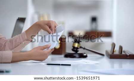 Divorced woman holding envelope with alimony, savings for single mom, allowance Royalty-Free Stock Photo #1539651971
