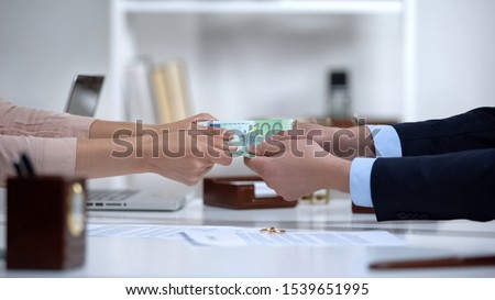 Man and woman hands pulling euro money, dividing marital property during divorce Royalty-Free Stock Photo #1539651995