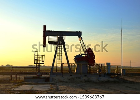 Oil drilling derricks at desert oilfield. Crude oil production from the ground. Oilfield services contractor. Oil drill rig and pump jack. Petroleum production, natural gas, liquids, NGL, additive.
