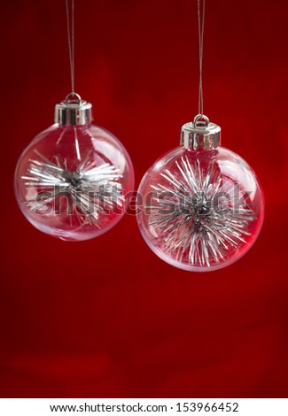 transparent Christmas Baubles on red background