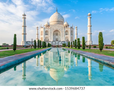 Amazing view on the Taj Mahal in sunset light with reflection in water. The Taj Mahal is an ivory-white marble mausoleum on the south bank of the Yamuna river. Agra, Uttar Pradesh, India.  Royalty-Free Stock Photo #1539684737