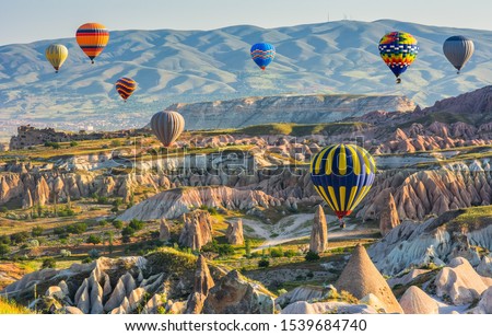 
Travel concept. The great tourist attraction of Cappadocia - balloon flight. Cappadocia one of the best places in the world to fly with hot air balloons. Goreme, Cappadocia, Turkey. Beauty world. Royalty-Free Stock Photo #1539684740